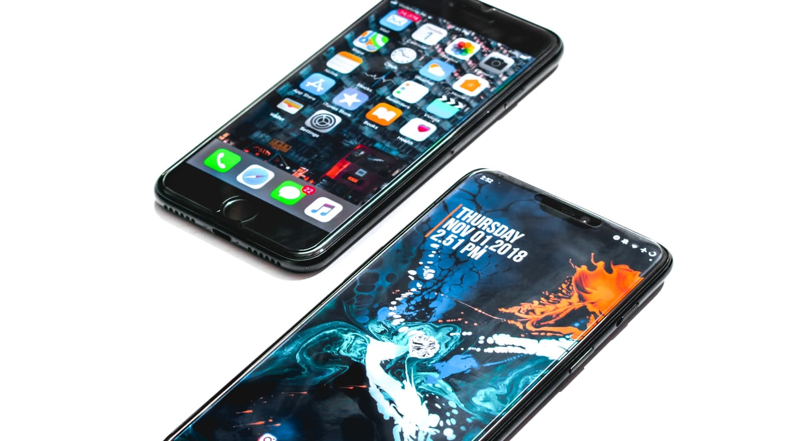 Two smartphones on a white desk