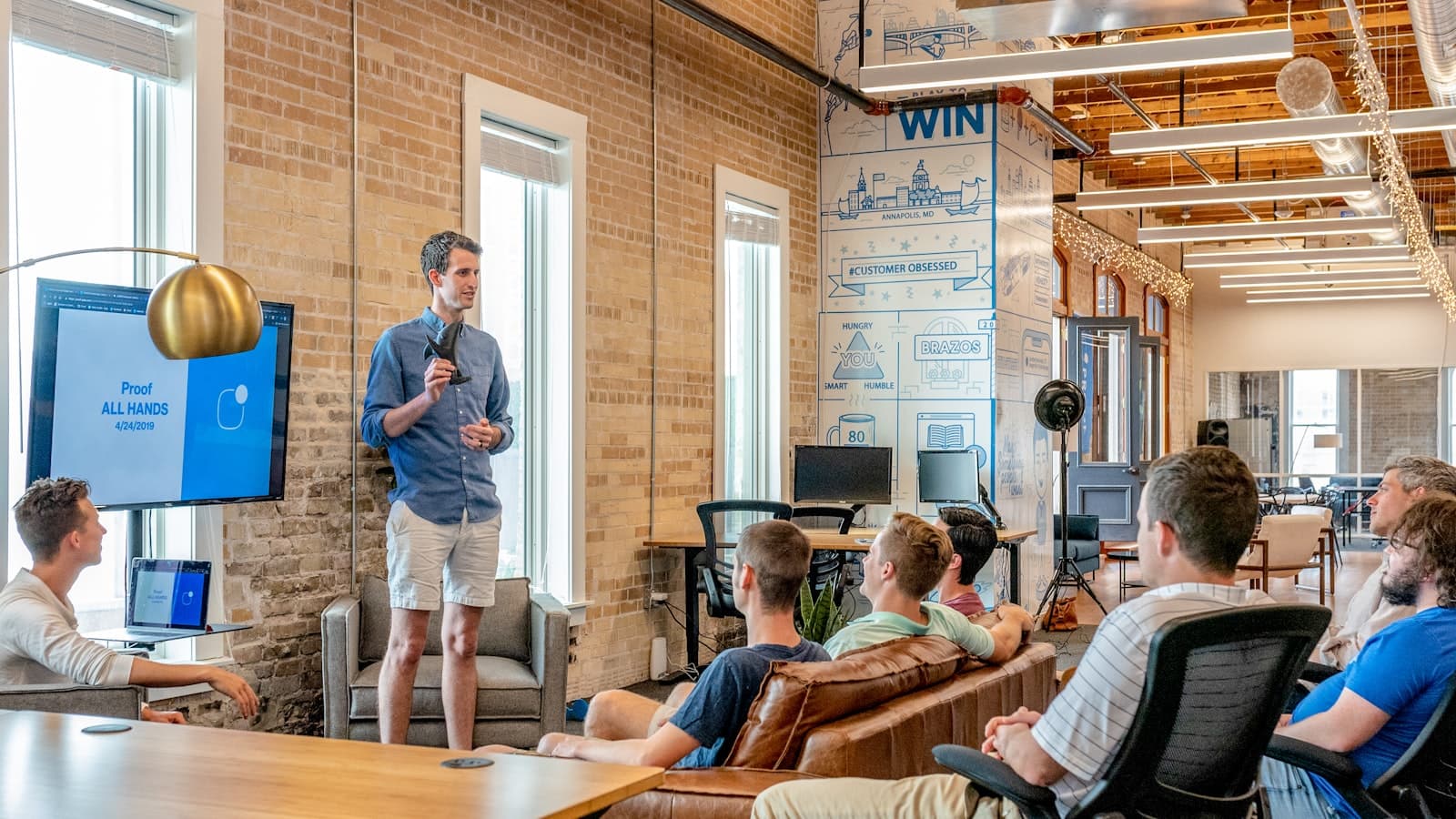 A team meeting around a presentation screen
