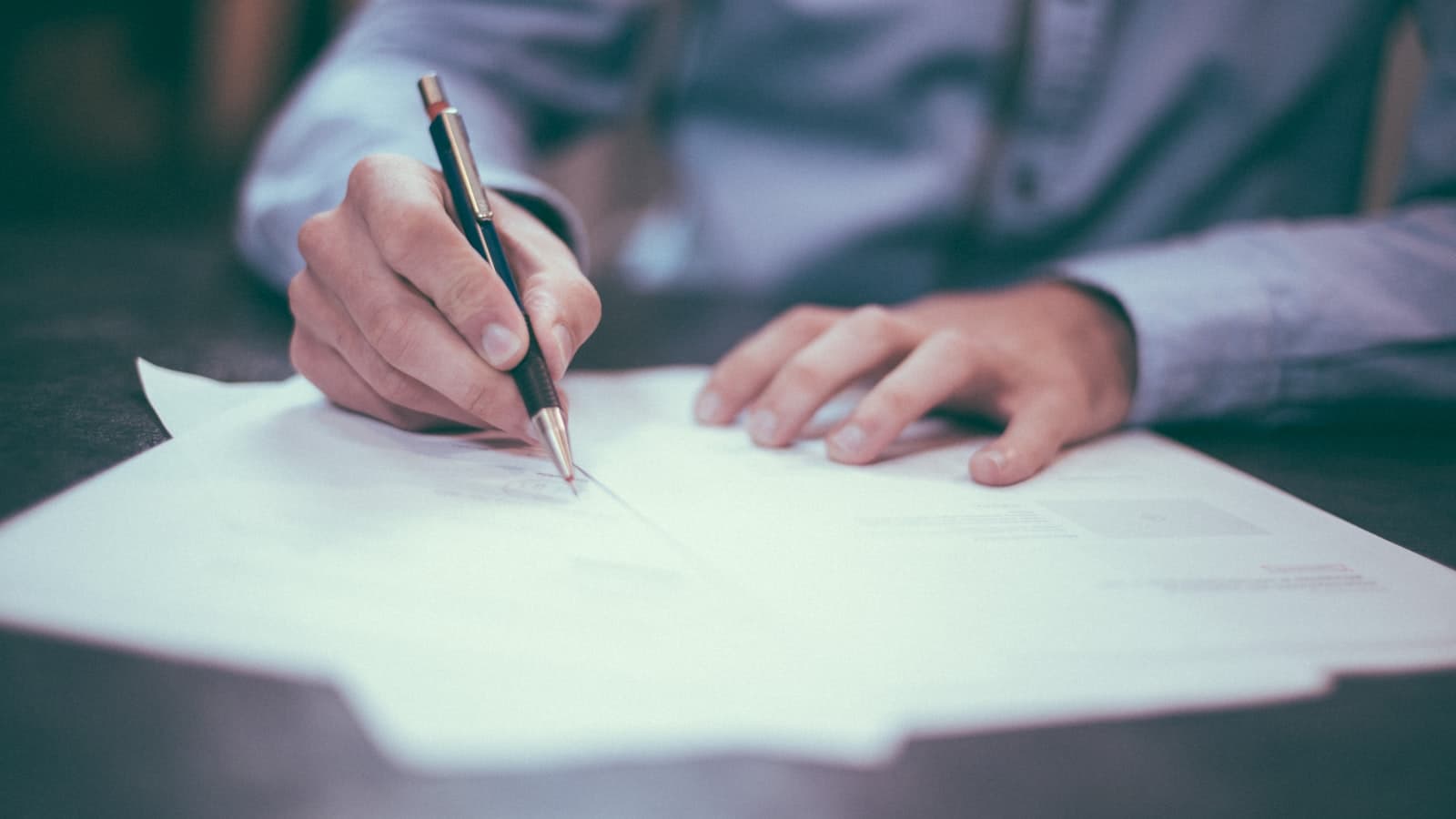Hands covering and marking a document
