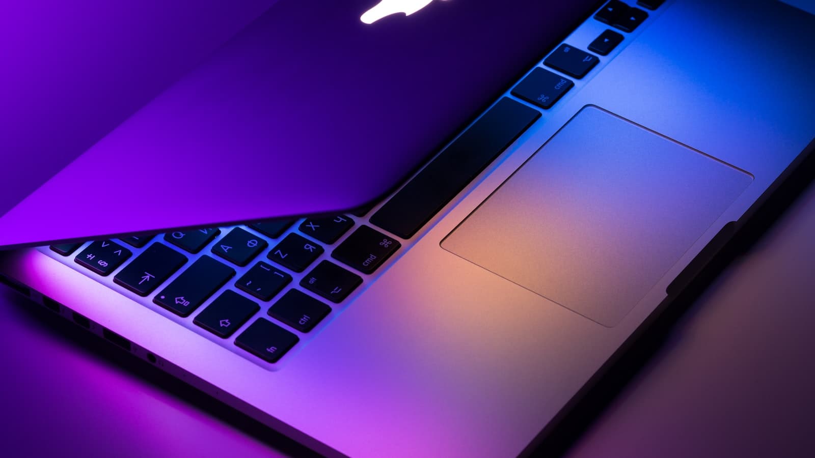 A space-gray MacBook with the Apple logo and Command keys visible