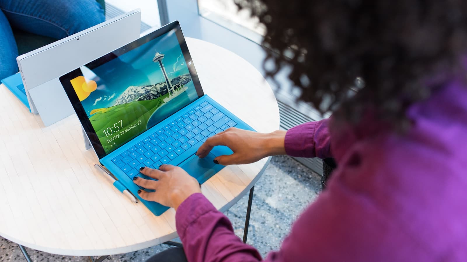 A Microsoft Surface running Windows, with the lock screen and Windows logo visible